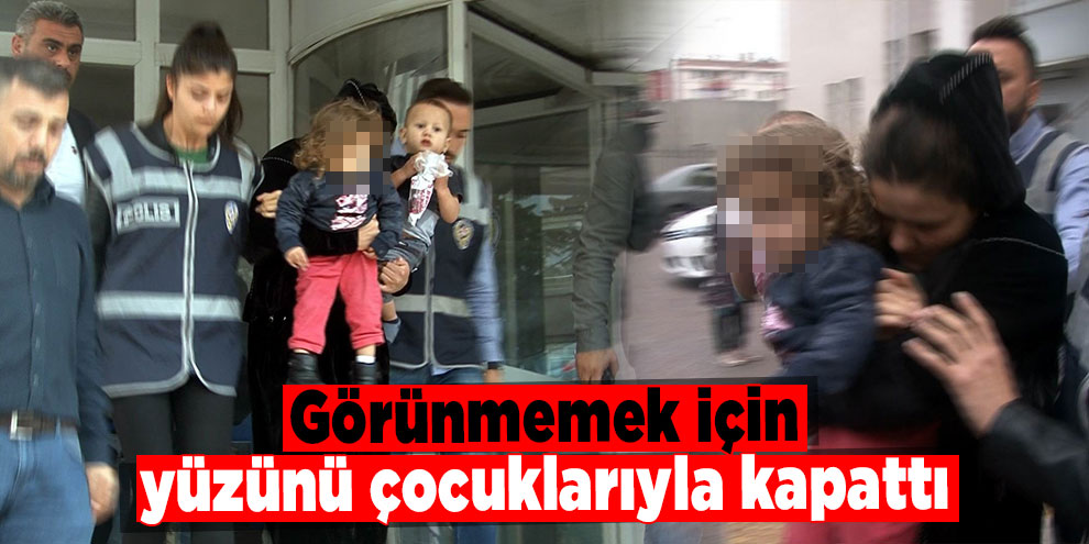 Görünmemek için yüzünü çocuklarıyla kapattı